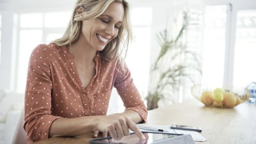 woman typing on an ipad