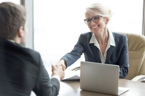 two people shaking hands after discussing loans