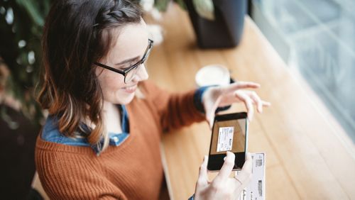 woman depositing a check using her phone
