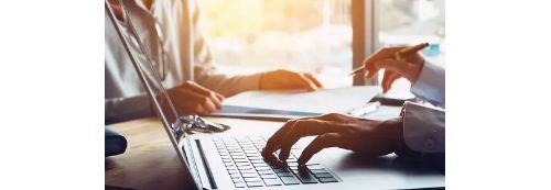 A person's hands typing on a laptop using integrated receivables.