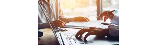 Hands on a laptop keyboard