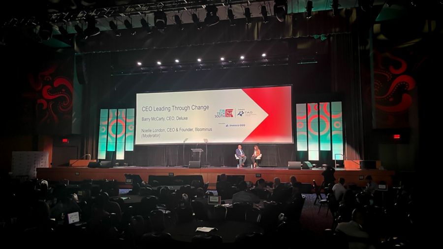 image of event stage with speakers and presentation