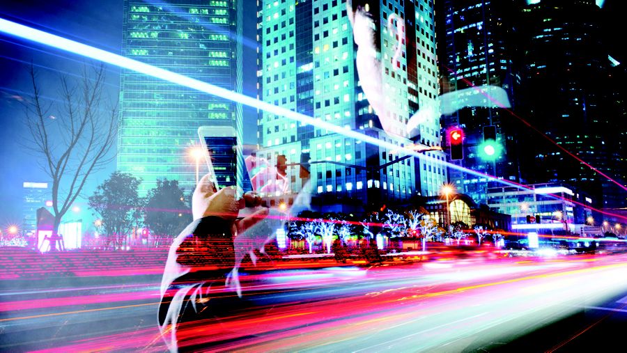 Tall buildings with an image overlay of a man using a cell phone. 