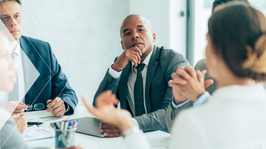 A businessman listening to his coworkers discuss AP