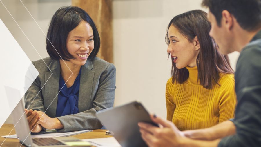 A woman working with a couple at a desk
