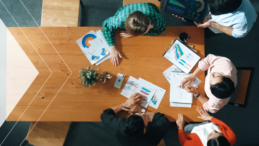 A group of people working at a desk 