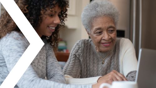 Two women looking at a laptop