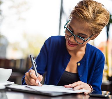 Woman writing a business check