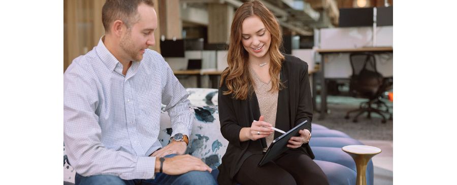 Deluxe coworkers review information on a digital tablet