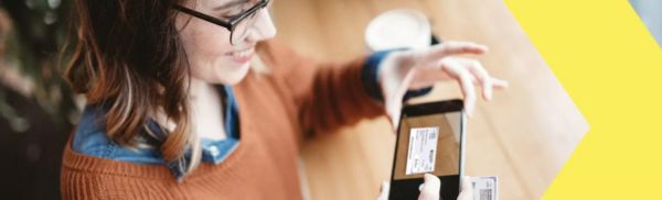 Woman takes a picture of a check with remote deposit capture
