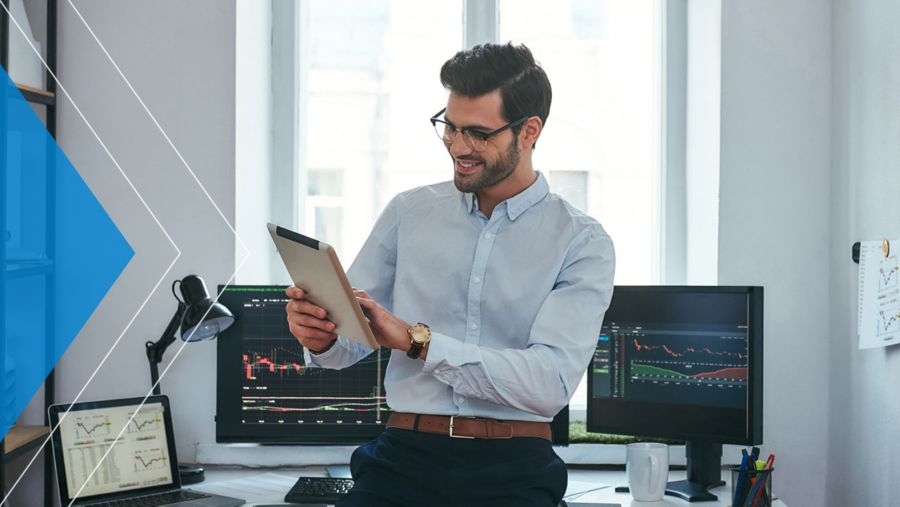 Businessman reviewing measurement analytics and smiling.
