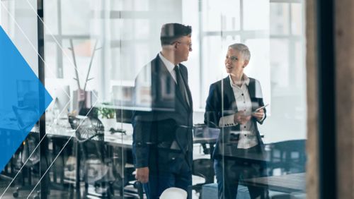 Bankers discussing bank performance and net interest margin in a conference room.