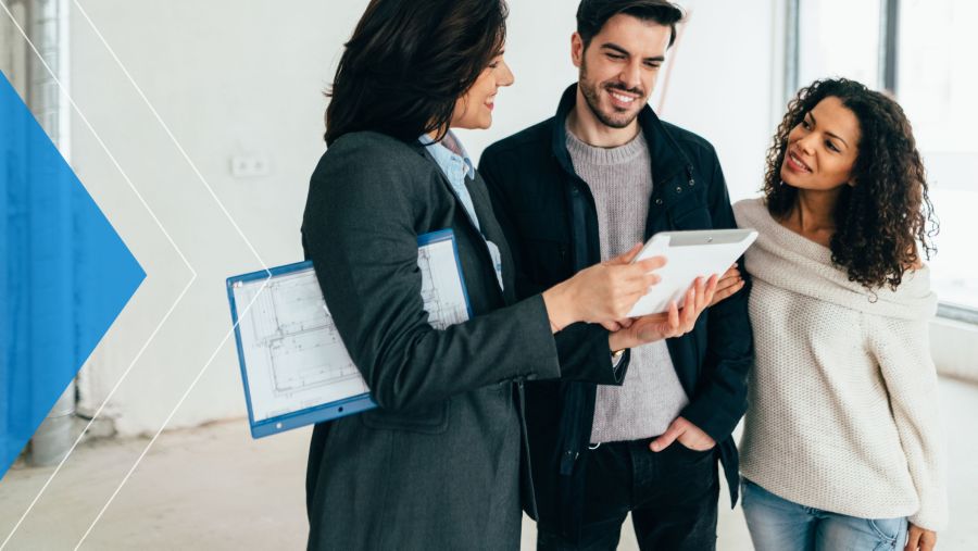 Young couple meeting with a real estate agent about a new home.