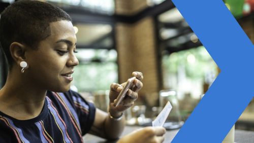 Young woman using her banking app to deposit a check into her new bank account