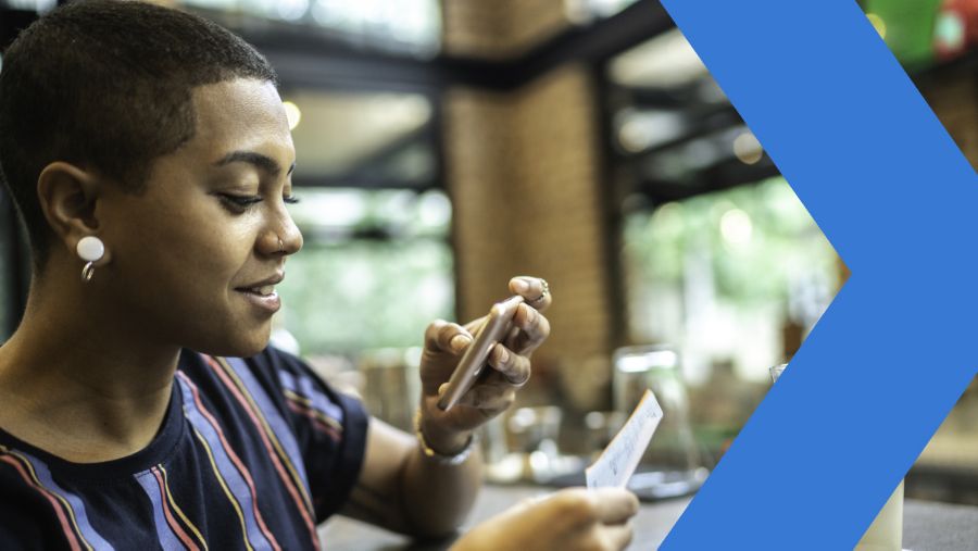 Young woman using her banking app to deposit a check into her new bank account