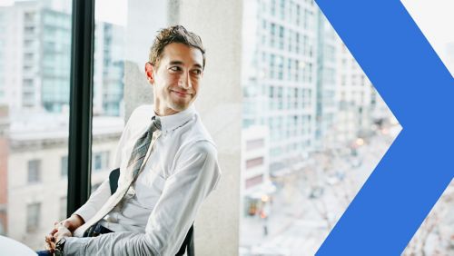 A businessman turning his head while smiling.