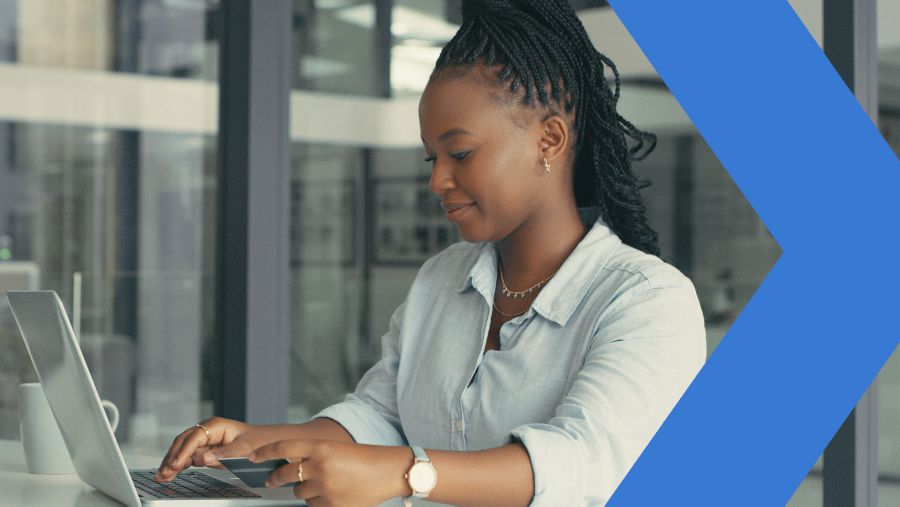 Woman working on laptop computer in office. 