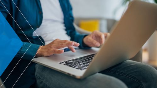 Man using his laptop to make an ACH donation.