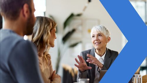 A financial institution employee meeting with business customers in an office.