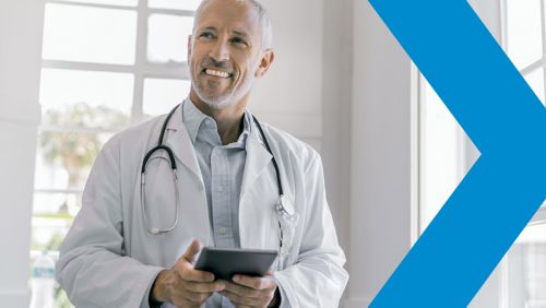 Doctor in white coat holding iPad