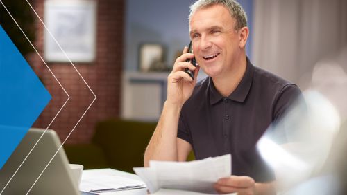 Older man on the phone with a Deluxe check expert