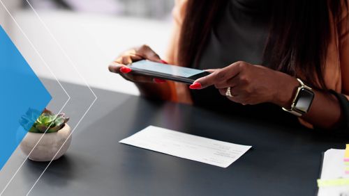 Woman uses mobile deposit capture to deposit check. 