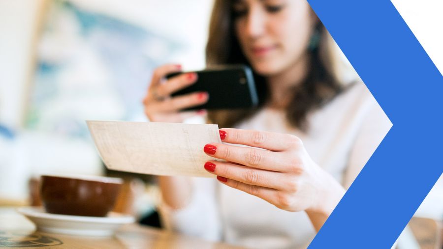 Female uses mobile deposit capture to deposit check. 