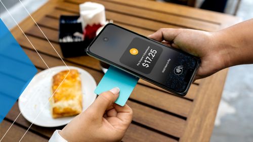 Merchant using their phone to accept payment