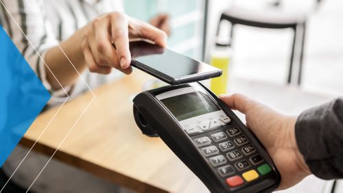 Woman using her smartphone to pay at a checkout stand.