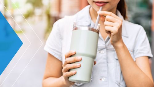 Woman sipping from a reusable tumbler