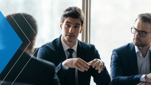 Banking leaders having a conversation at a conference table