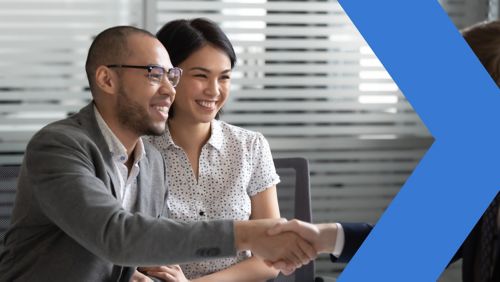 Business owners shaking hands with a banker