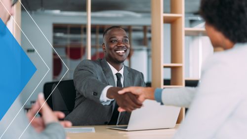 Merchant shaking hands with a banker.