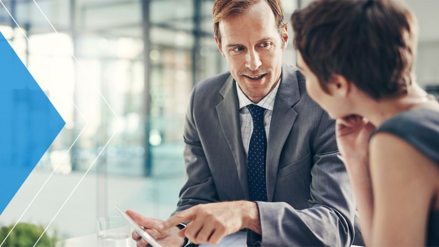 A banker meeting with a business customer in an office.