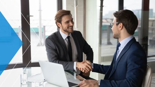 Business owners shaking hands with a banker