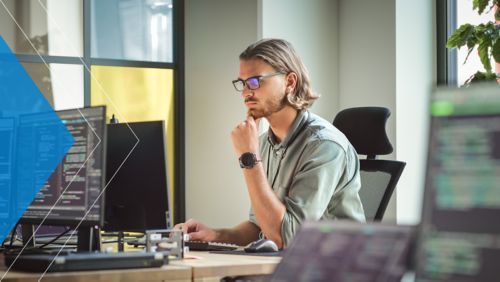 Developer working on a project at his office desk.