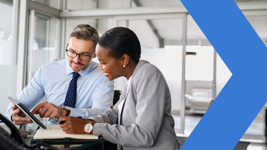 Two bankers using predictive analytics in an office meeting.