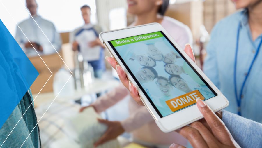Woman making a donation on an iPad in a crowded area