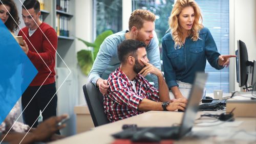 Group of nonprofit employees around a computer screen.