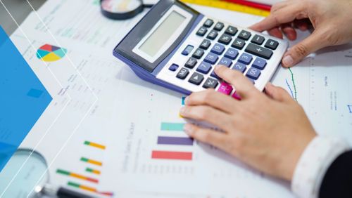 Nonprofit bookkeeper crunching the numbers on a calculator.
