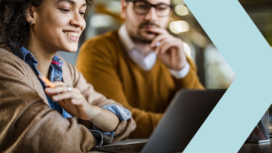 man and woman working on laptop