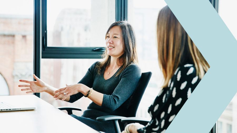 Community banker discussing mergers and acquisitions with a colleague