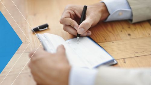 Closeup of man writing a check