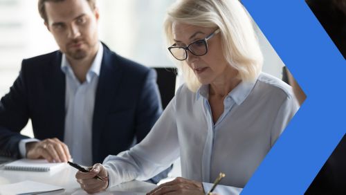 woman holding pen in meeting 