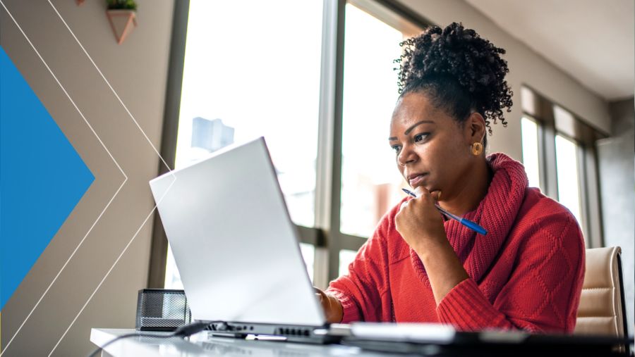 Nonprofit leader at her desk, browsing on her laptop.