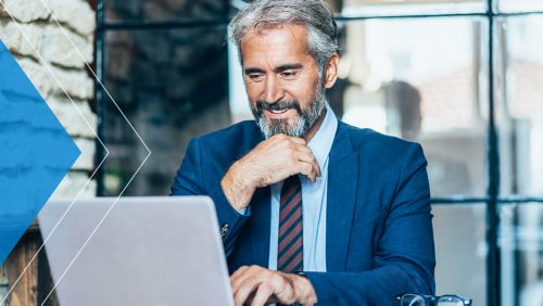 A businessman turning his head while smiling.