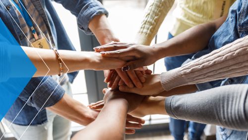 Group of nonprofit employees putting their hands together