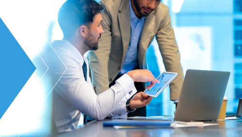 Two treasury professionals meeting to discuss Generative AI in finance. 