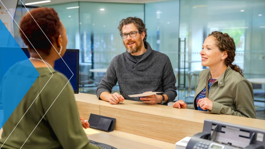 Couple at a desk inside a bank branch