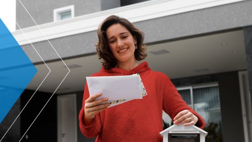 Woman receiving direct mail marketing in her mailbox.